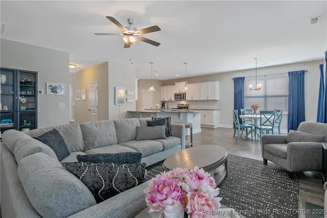 a living room with furniture and kitchen view