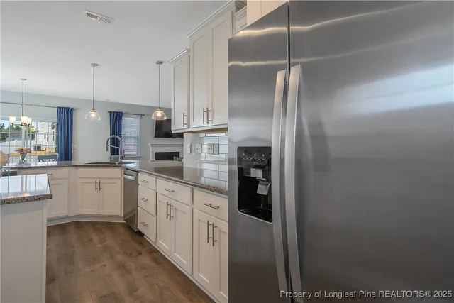 a kitchen with cabinets and a refrigerator