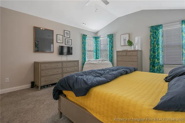 a bedroom with a bed and a television