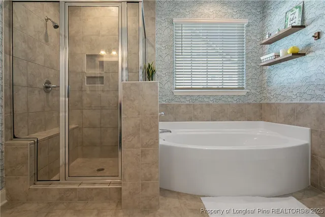 a white bath tub sitting next to a shower