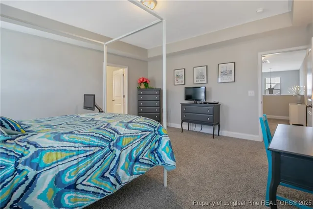 a bedroom that has a bed and a chair in it