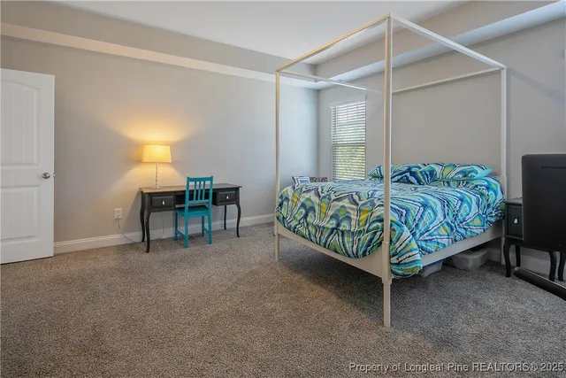 a bedroom with a bed and a table in it