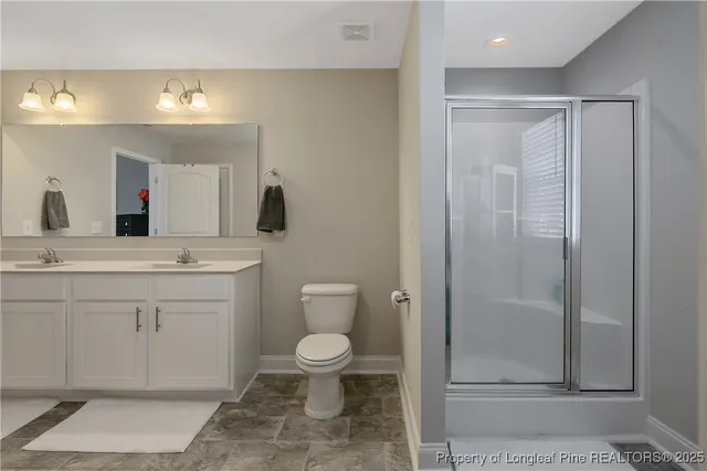 a bathroom with a toilet sink and shower