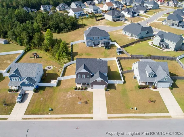 an aerial view of residential houses with outdoor space