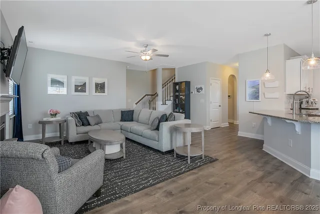 a living room with furniture and a chandelier