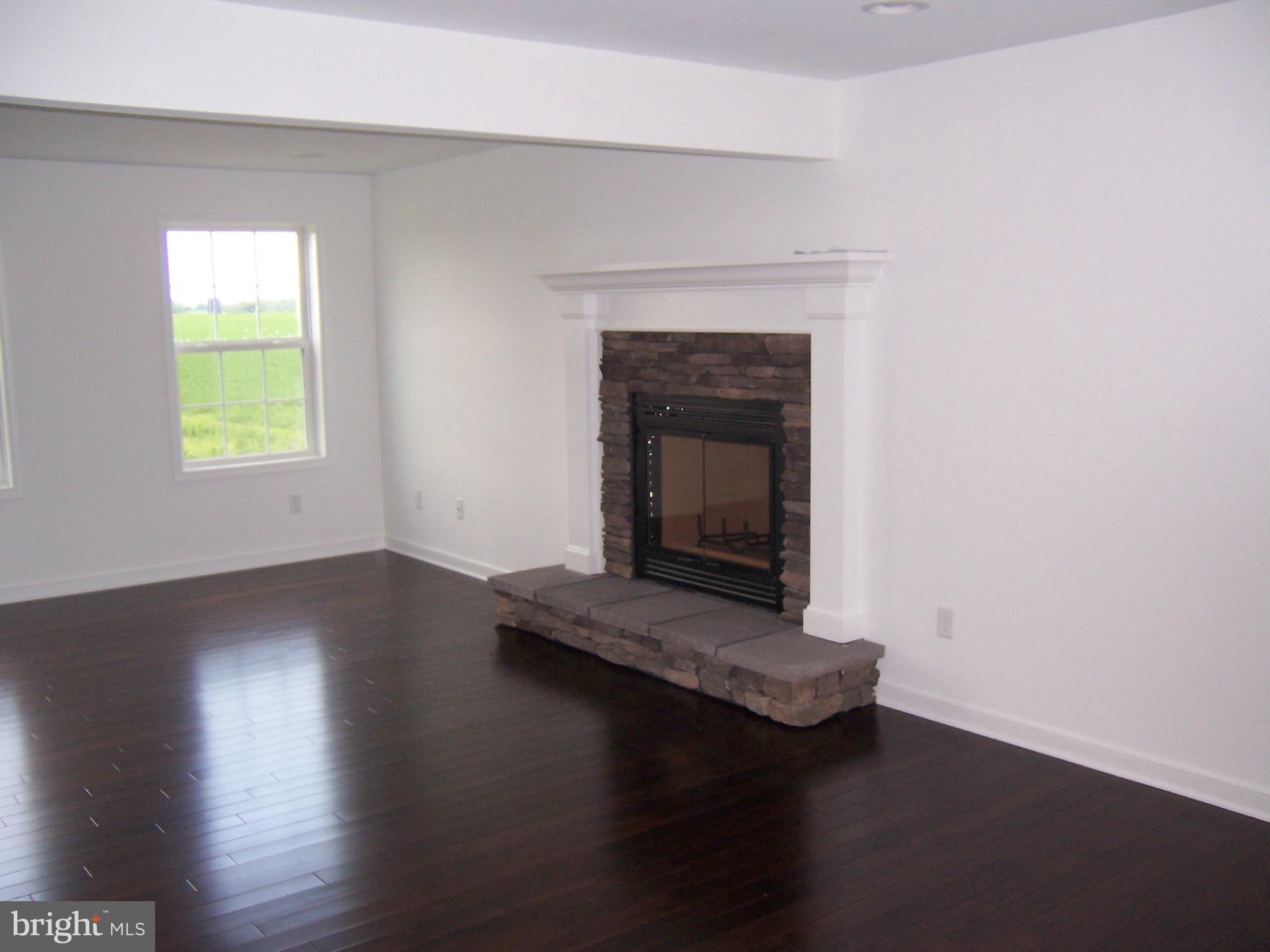 11741 Ashton Road Clear Spring, MD 21722 - Photo 2 of 9 a living room with hard wood floors and a fireplace