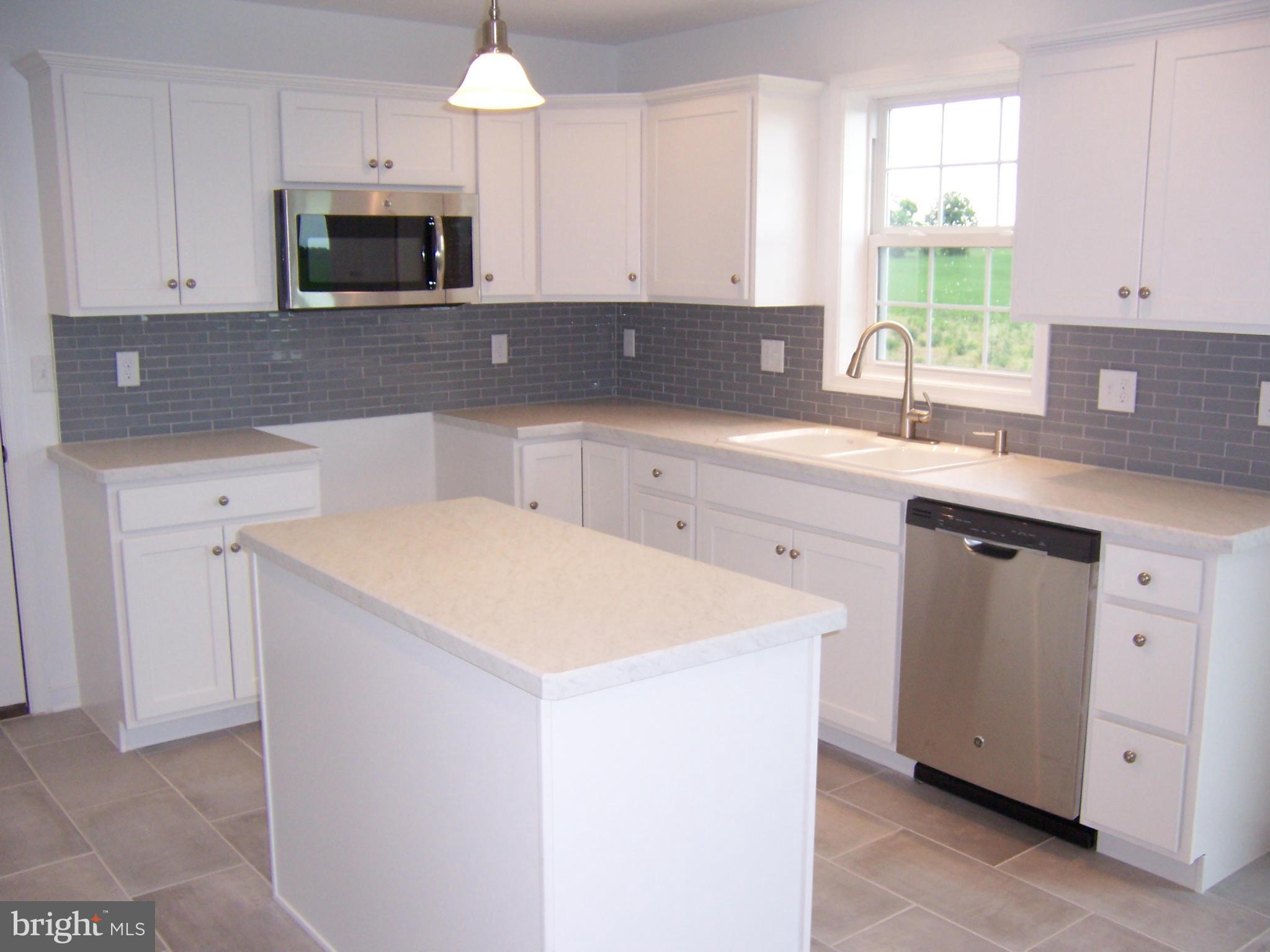 11741 Ashton Road Clear Spring, MD 21722 - Photo 4 of 9 a kitchen with stainless steel appliances a sink a stove a microwave a sink and cabinets