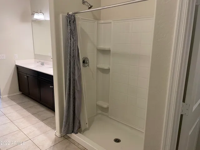 a bathroom with a shower and a sink