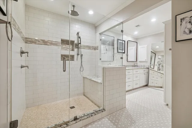 a bathroom with a shower sink and mirror