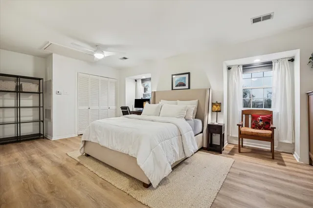 a bedroom with a bed and a painting on the wall
