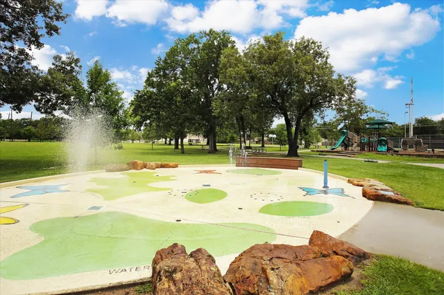 a view of a swimming pool with a lawn chairs and plants