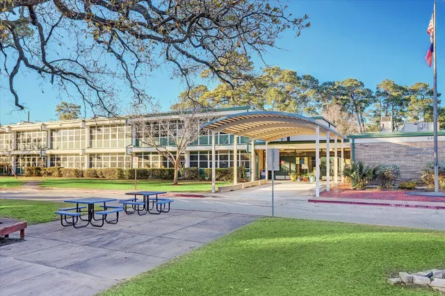 a view of a patio with a table and chairs under an umbrella