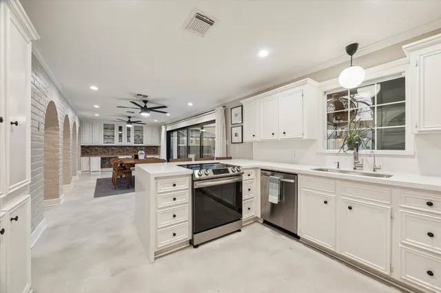 a kitchen with white cabinets and white appliances
