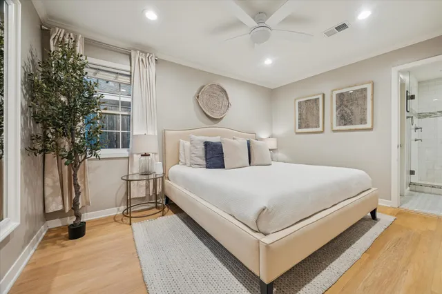 a bedroom with a bed and a potted plant