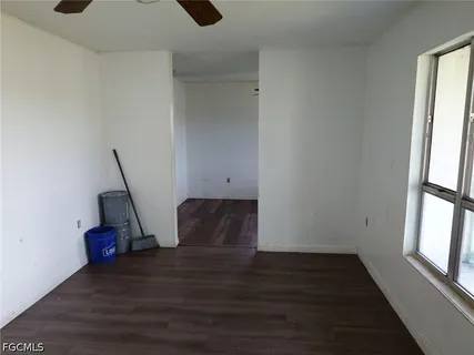 a view of wooden floor and windows in a room
