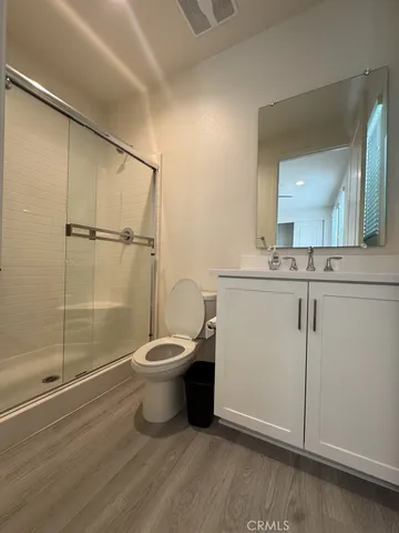 a bathroom with a toilet a sink and shower