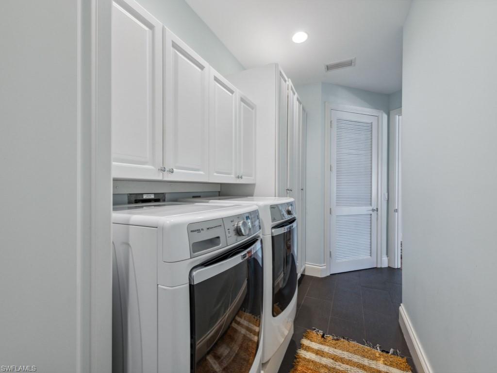 625 5th Avenue South, Unit PH302 Naples, FL 34102 - Photo 21 of 33 Washroom featuring cabinets and washer and dryer