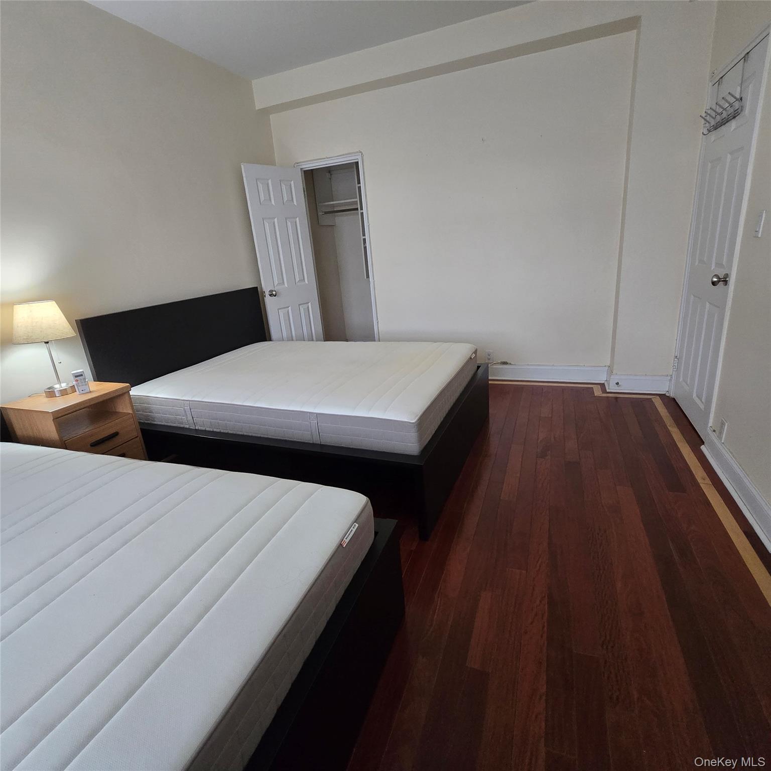 99-40 63rd Road, Unit 1O Queens, NY 11374 - Photo 12 of 14 a bedroom with double bed and a night stand