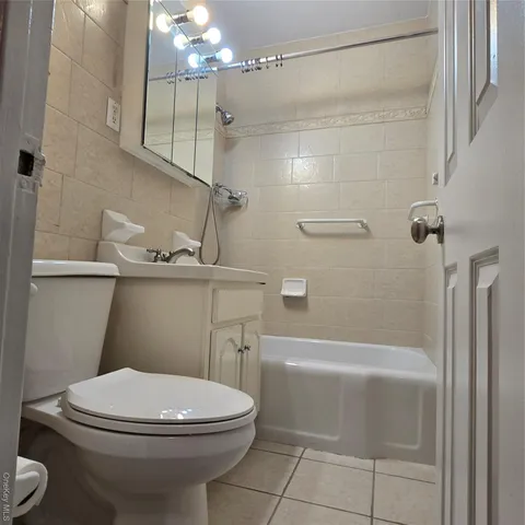 a bathroom with a toilet a sink and shower