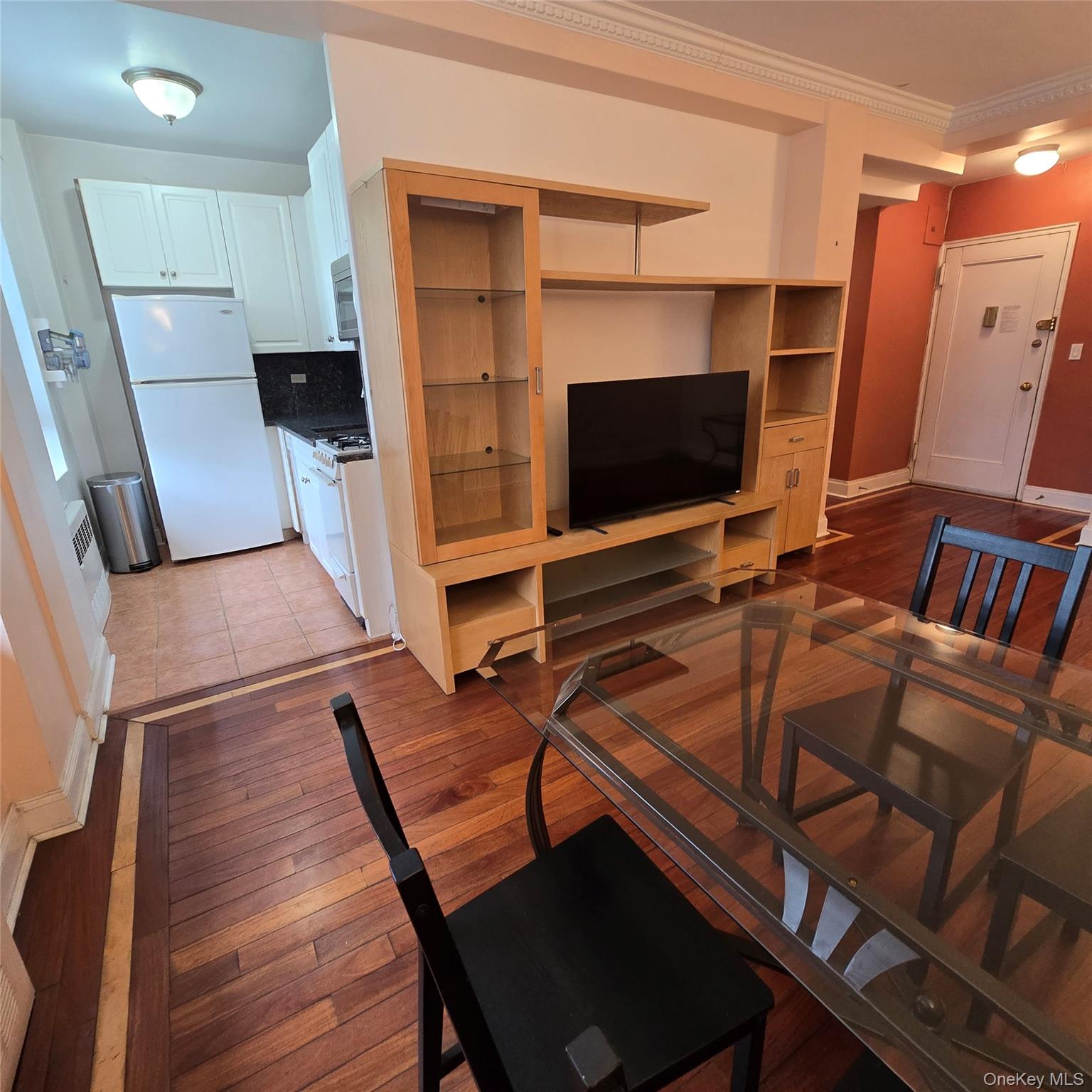 99-40 63rd Road, Unit 1O Queens, NY 11374 - Photo 6 of 14 a bedroom with a bed and a flat screen tv