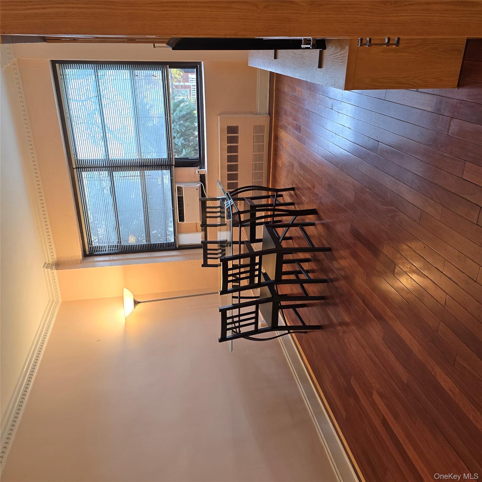 99-40 63rd Road, Unit 1O Queens, NY 11374 - Photo 7 of 14 a view of a dining room with furniture and wooden floor