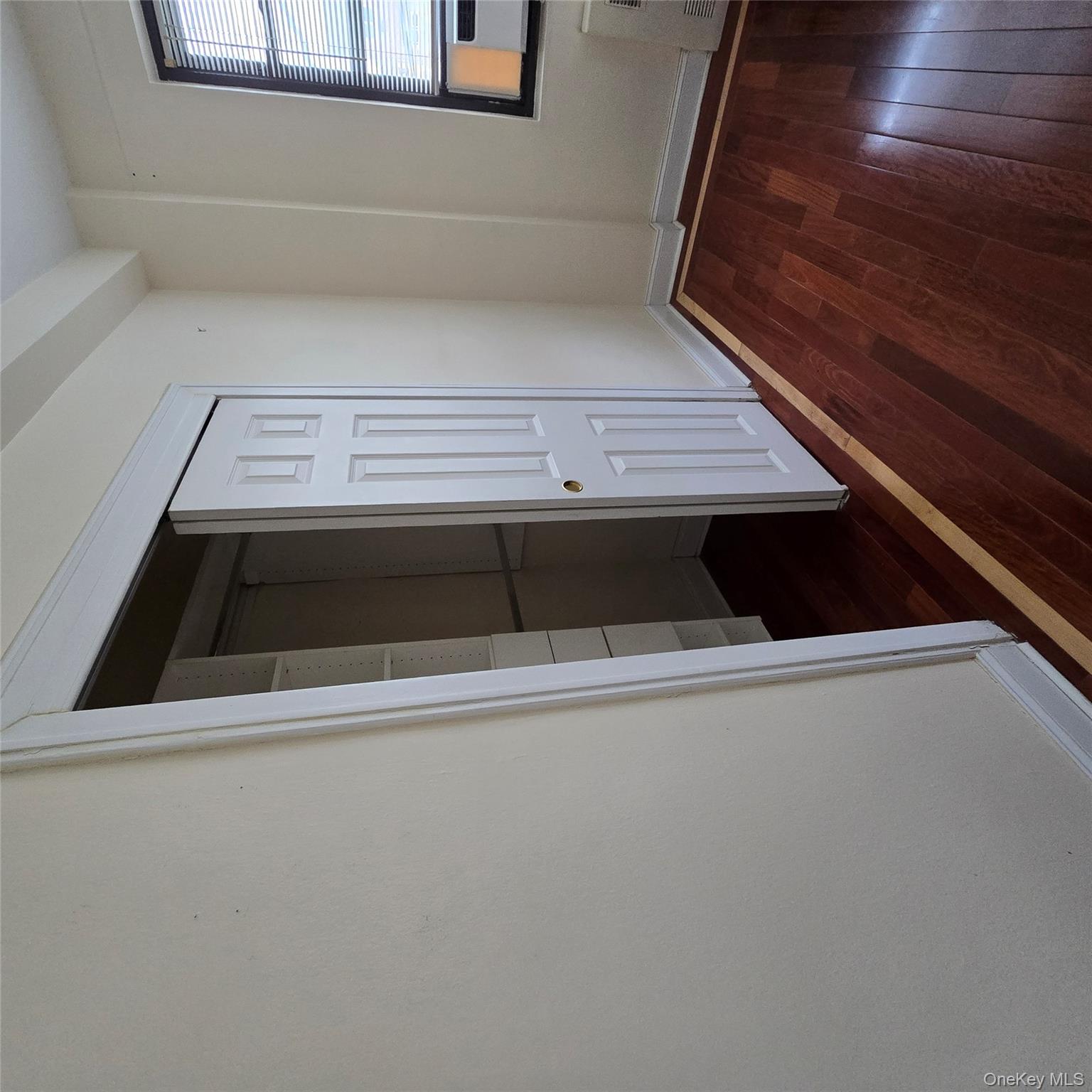 99-40 63rd Road, Unit 1O Queens, NY 11374 - Photo 10 of 14 an empty room with wooden floor and windows