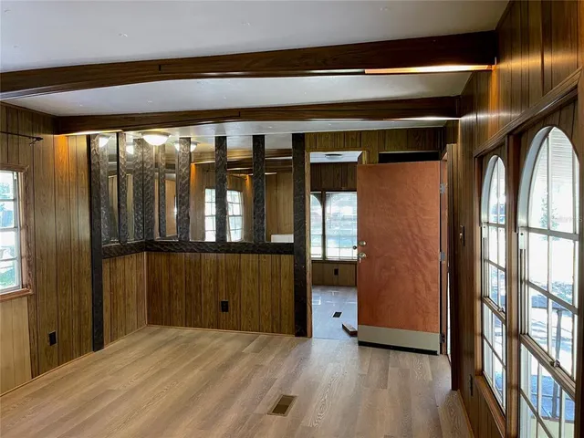 a view of empty room with wooden floor