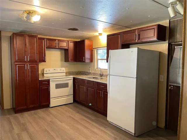 a kitchen with stainless steel appliances a refrigerator and a stove top oven