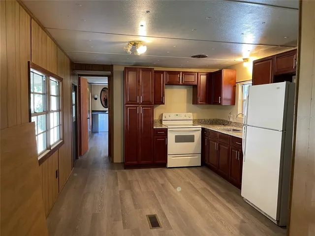 a kitchen with a sink stove and refrigerator