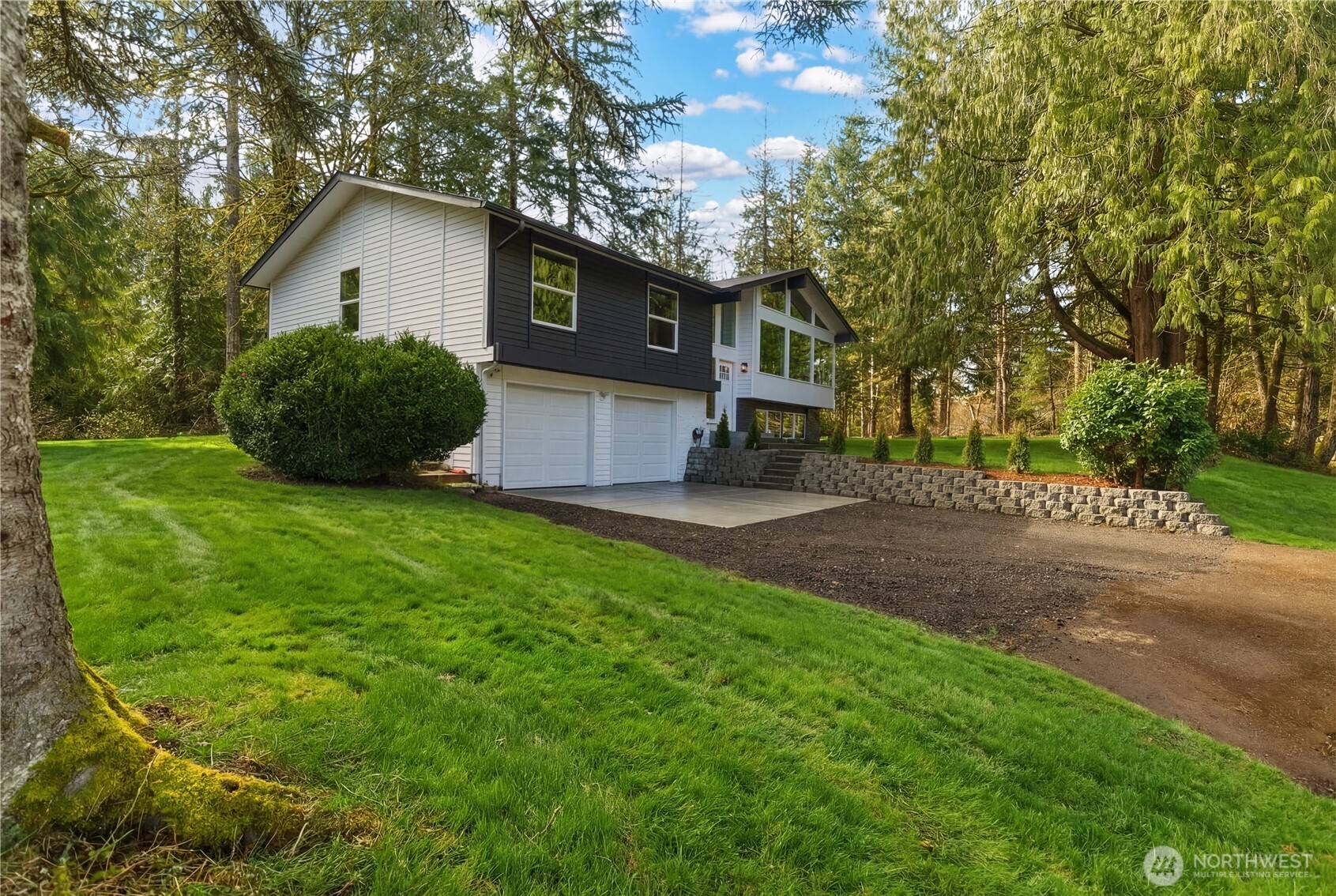 5205 59th Court Southwest Olympia, WA 98512 - Photo 2 of 39 a view of a backyard with a garden and tree