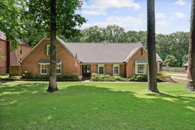 a front view of house with yard and green space