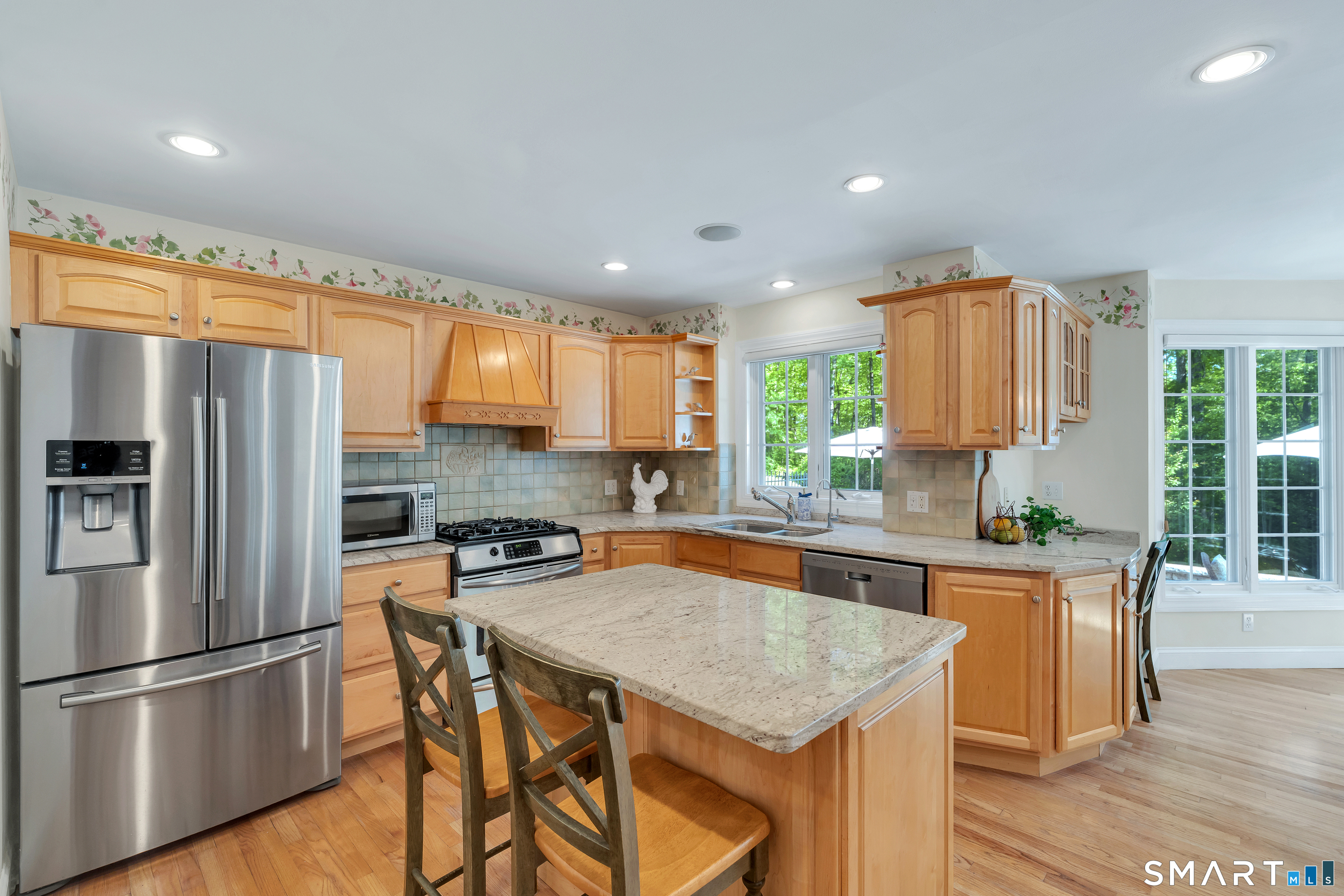 21 Stone Wall Road Salem, CT 06420 - Photo 15 of 38 a kitchen with granite countertop a refrigerator a stove a sink dishwasher and wooden cabinets with wooden floor