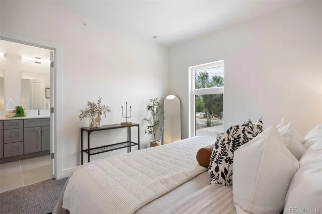 a bedroom with a bed and a table