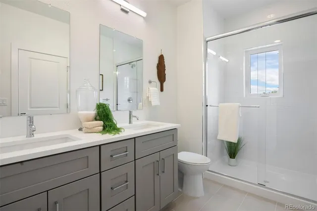 a bathroom with a granite countertop sink a toilet and a mirror