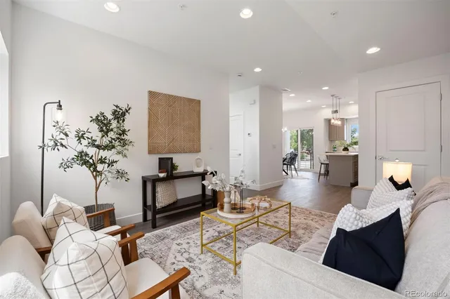 a living room with furniture and a potted plant
