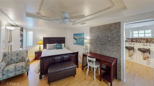 a bedroom with furniture and wooden floor