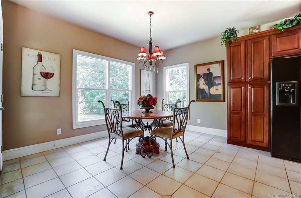421 Greenbay Road Mooresville, NC 28117 - Photo 12 of 25 a dining room with furniture a chandelier and window