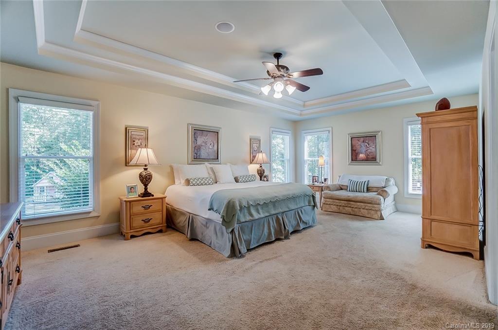421 Greenbay Road Mooresville, NC 28117 - Photo 13 of 25 a spacious bedroom with a bed and a chandelier