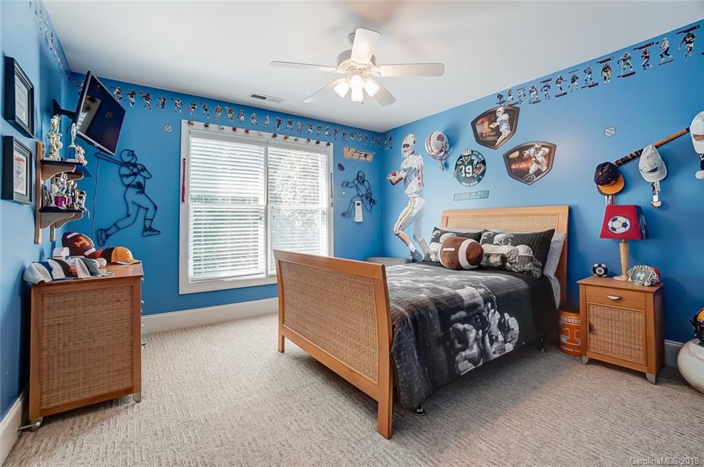 421 Greenbay Road Mooresville, NC 28117 - Photo 16 of 25 a bedroom with a bed and a chandelier
