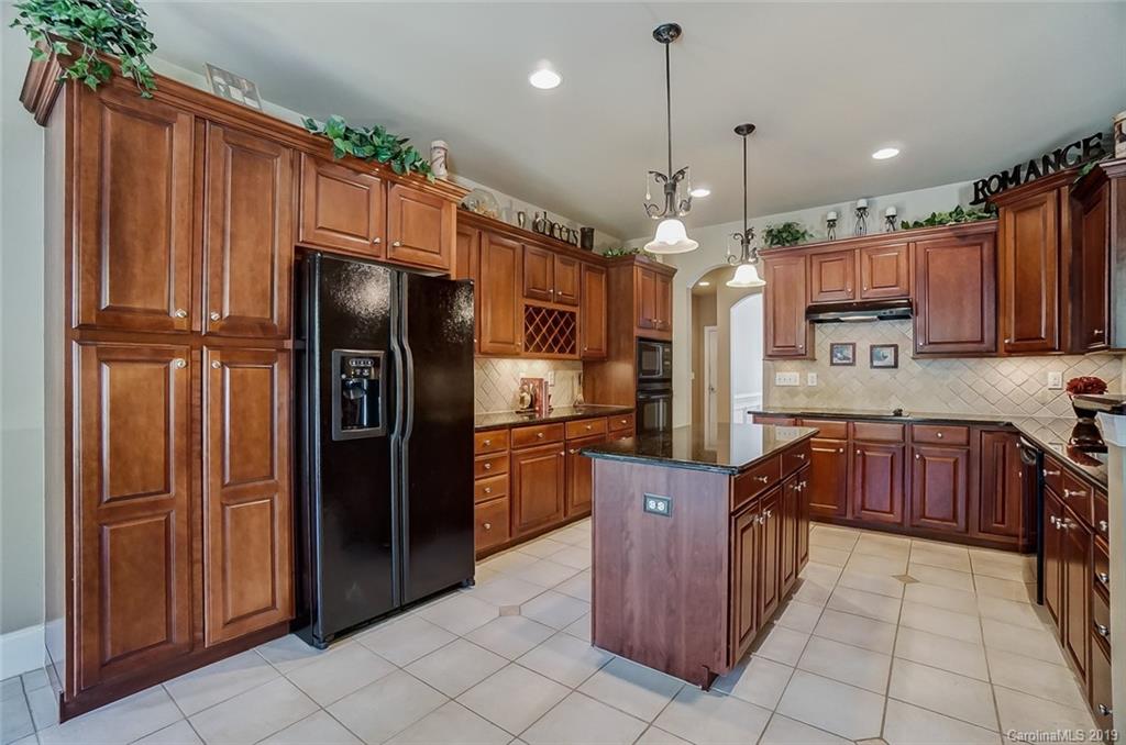 421 Greenbay Road Mooresville, NC 28117 - Photo 9 of 25 a kitchen with stainless steel appliances granite countertop a refrigerator and a sink