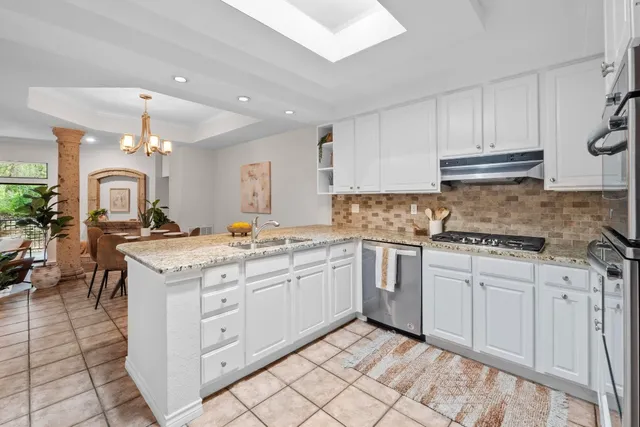 a kitchen with a sink stove and cabinets