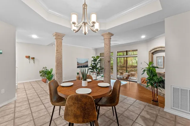 a view of a dining room with furniture and chandelier