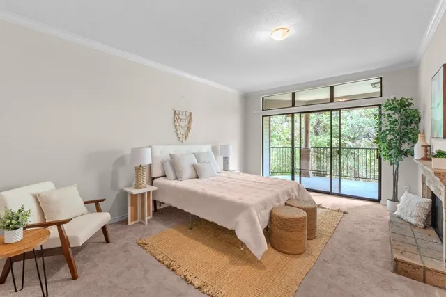a bedroom with a bed and glass window