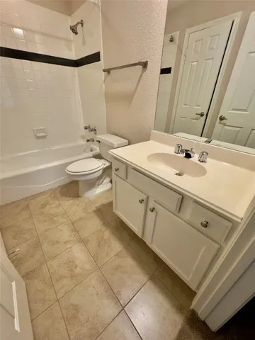 a bathroom with a double vanity sink toilet and shower