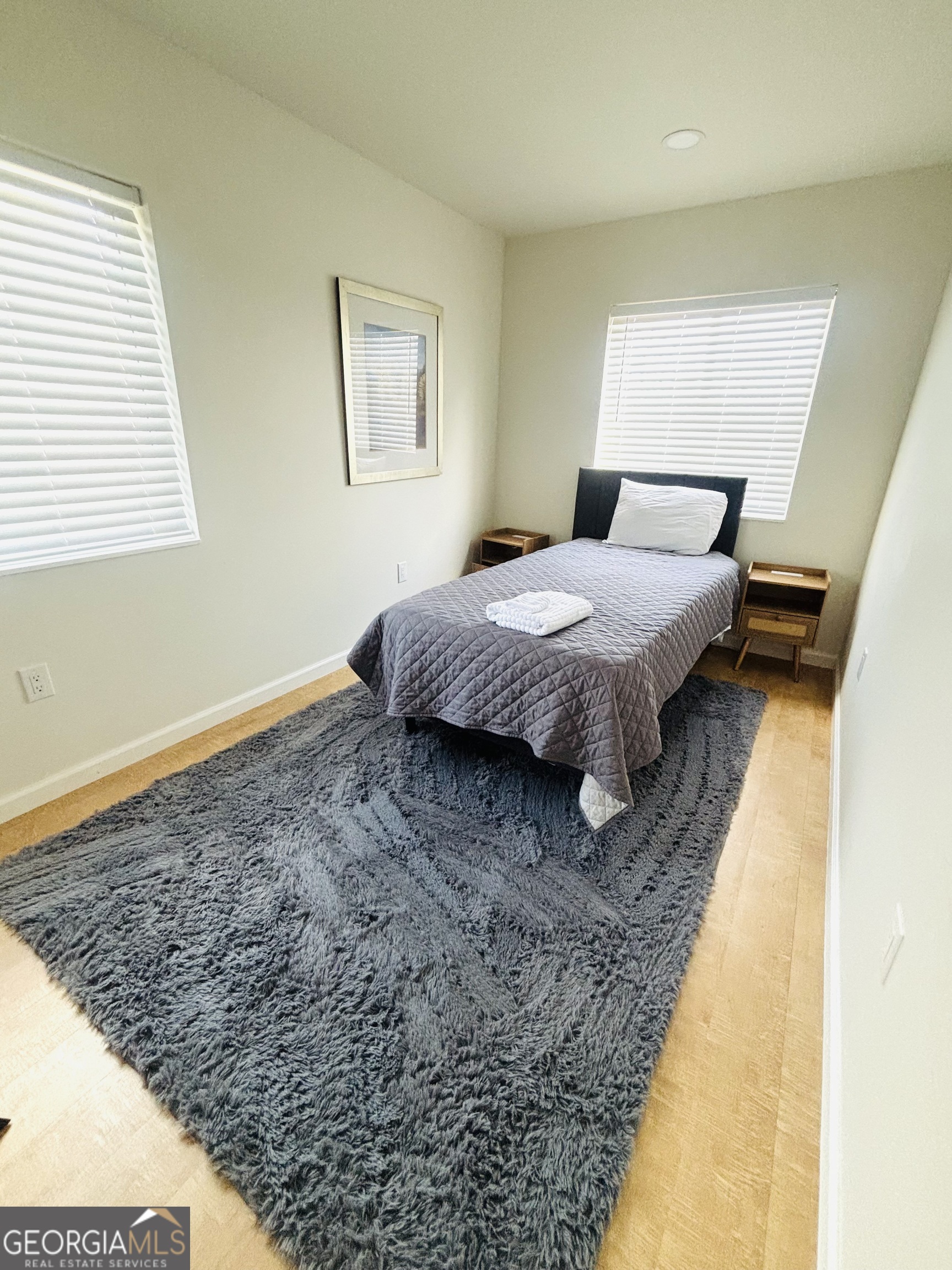 364 Rosen Strasse Helen, GA 30545 - Photo 27 of 45 a bedroom with a bed rug and wooden floor