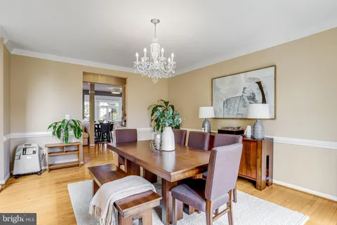 a dining room with furniture and chandelier
