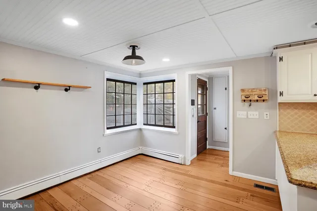 a kitchen with kitchen island granite countertop a stove and a refrigerator