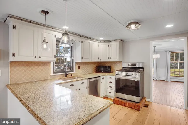 a kitchen with granite countertop a stove and a sink