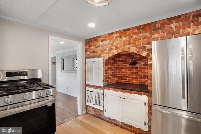 an empty room with wooden floor and window
