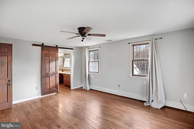 a bathroom with a sink a toilet a mirror and shower